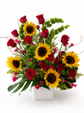 Bouquet of red roses and sunflowers with greenery in a white box on a white background