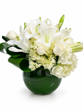Bouquet of white and light green flowers in a green vase on a white background