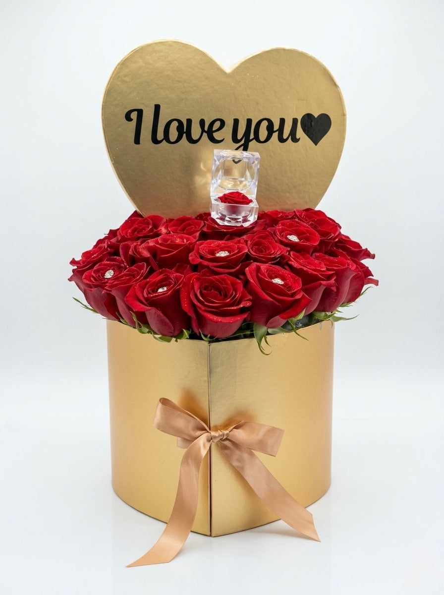 Gold heart-shaped box with fresh red roses and a ring box, featuring 'I love you' text.